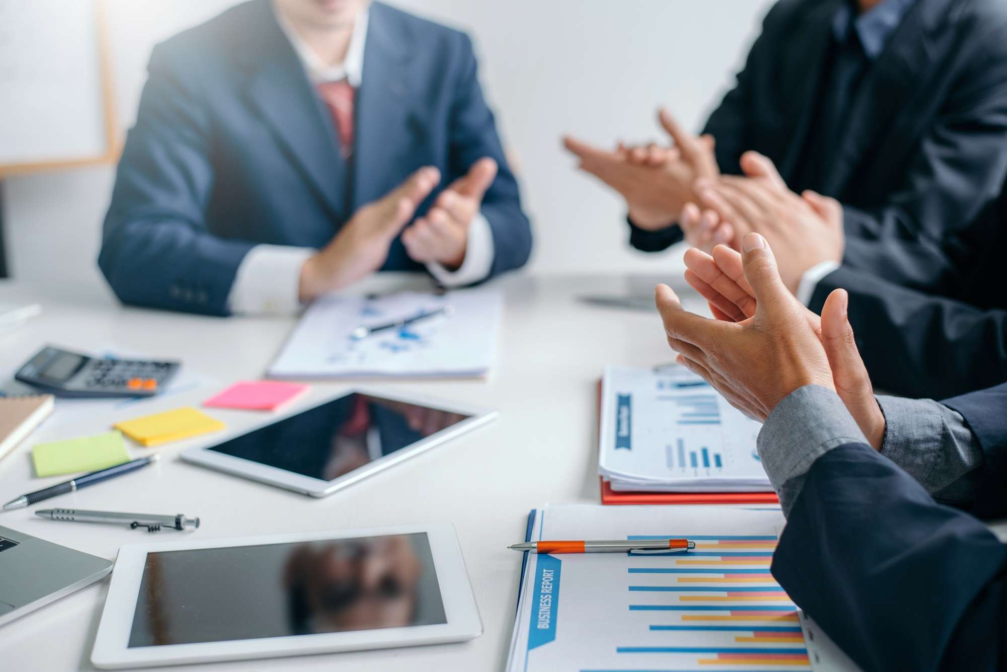 Business success. Businessman clapping and congratulated during the meeting.