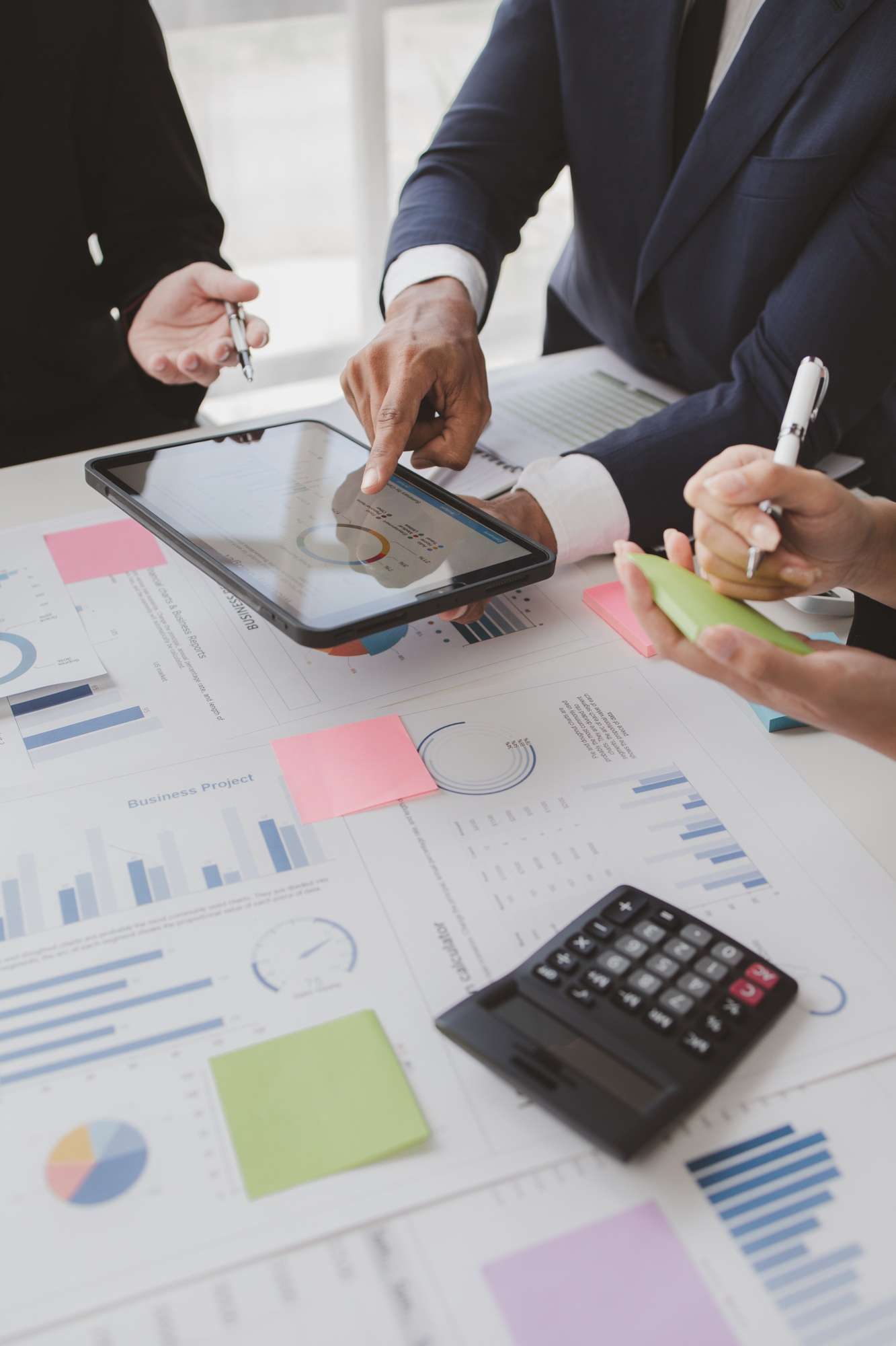 Businessman is reviewing monthly sales documents for analysis and marketing plans for more sales gro