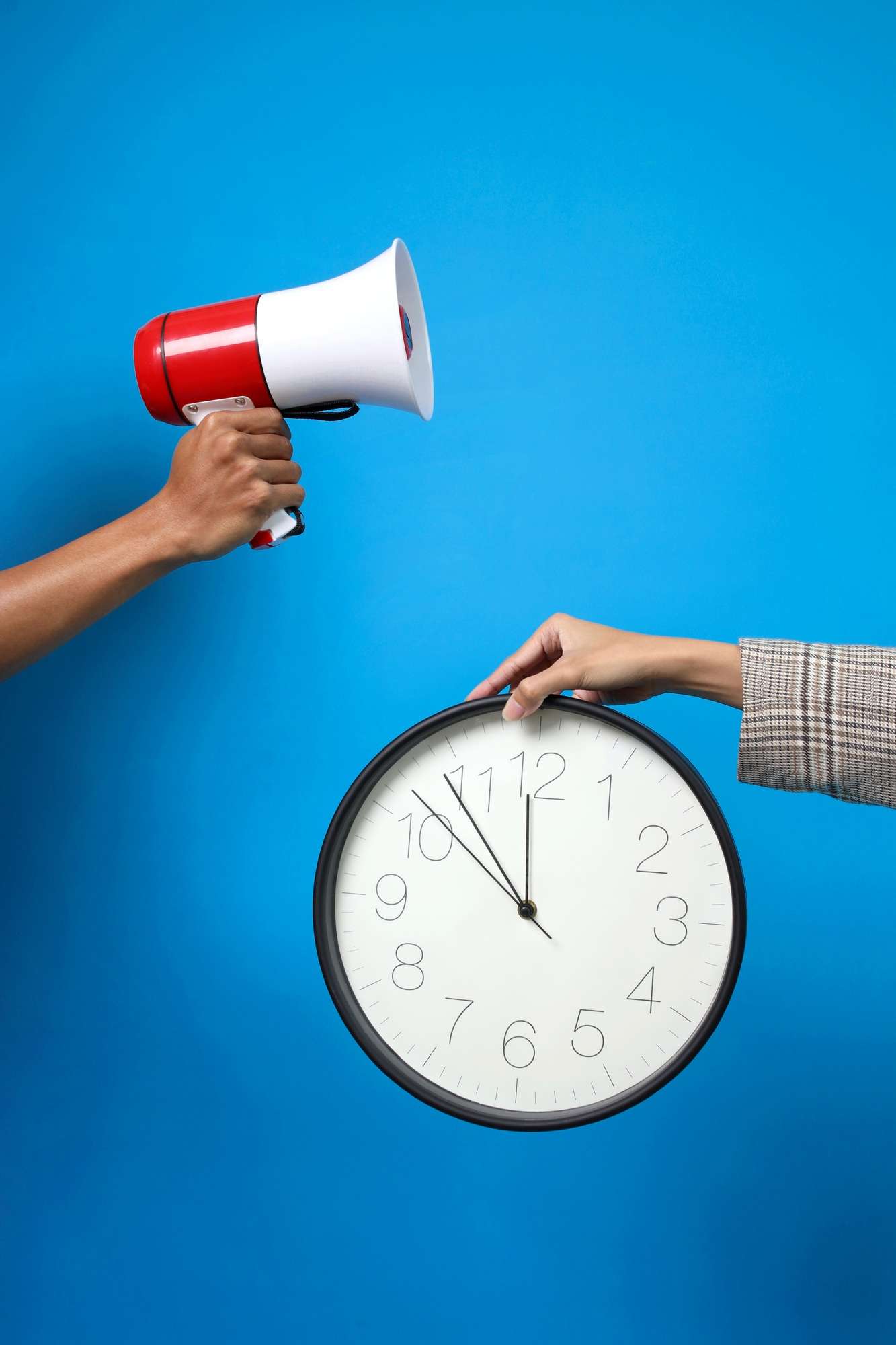 Hands Holding Megaphone And Clock For Advertisement