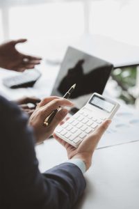 Businessman is reviewing monthly sales documents for analysis and marketing plans for more sales gro