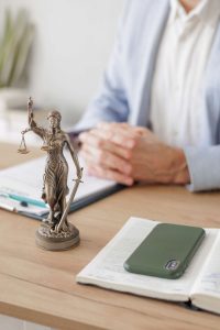 legal advice in the office or online. a male lawyer checks a legal contract and works on a laptop